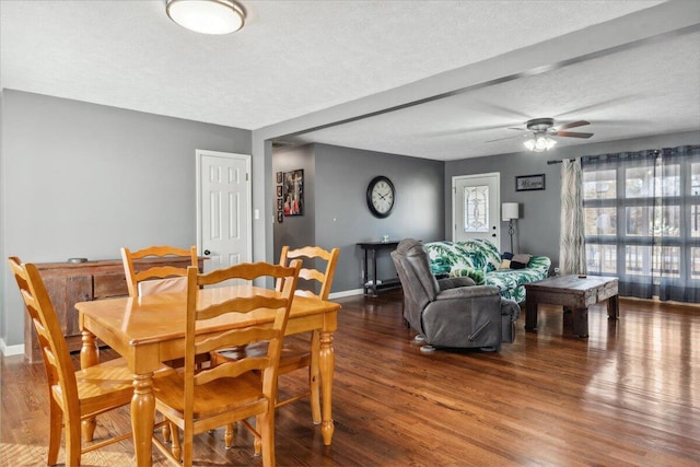 dining area with hardwood / wood-style floors, a textured ceiling, and ceiling fan