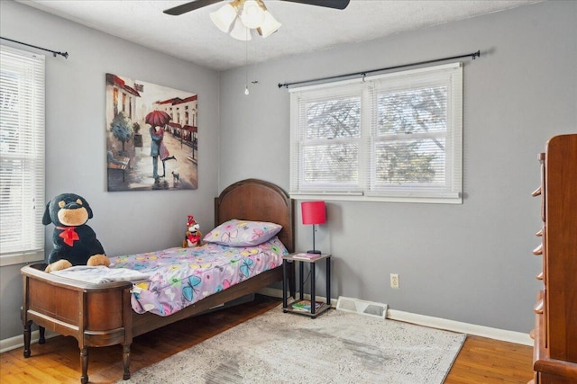 bedroom with hardwood / wood-style floors and ceiling fan