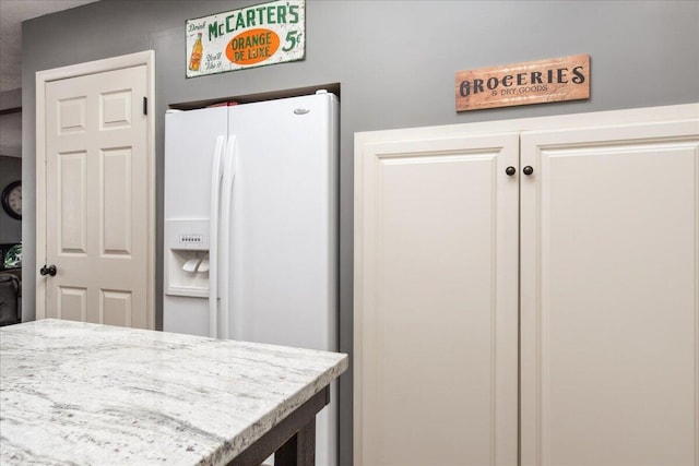 kitchen with white refrigerator with ice dispenser