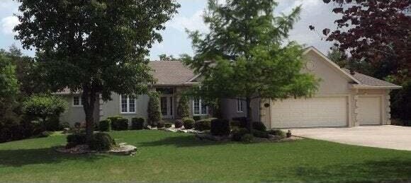 view of front of property with a front yard and a garage