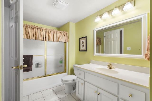 full bathroom with shower / bath combination with glass door, vanity, tile patterned floors, and toilet