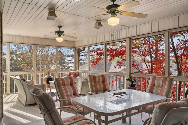 sunroom with ceiling fan and wood ceiling