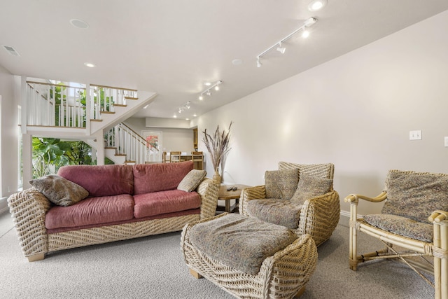 carpeted living room with rail lighting