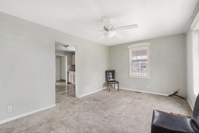 carpeted empty room featuring ceiling fan