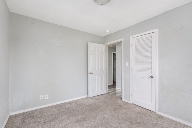 unfurnished bedroom featuring light carpet