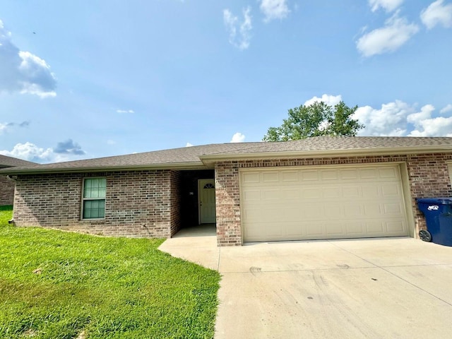 ranch-style house with a garage and a front lawn