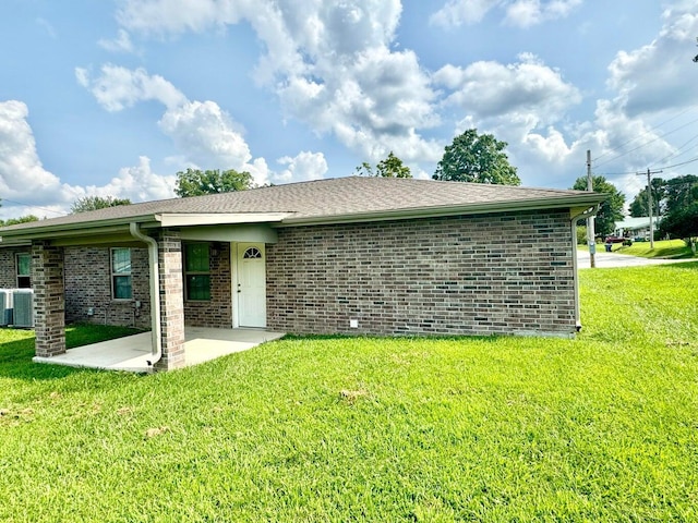 exterior space with a yard, a patio, and central AC unit