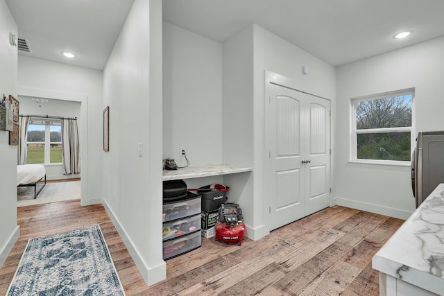 8532 County Road 6890, West Plains, MO 65775 - bedroom with light hardwood / wood-style floors, washer / dryer, and a closet