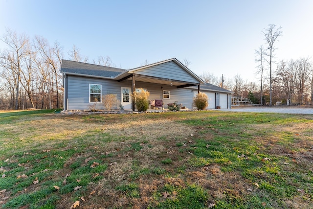 single story home featuring a garage and a front lawn