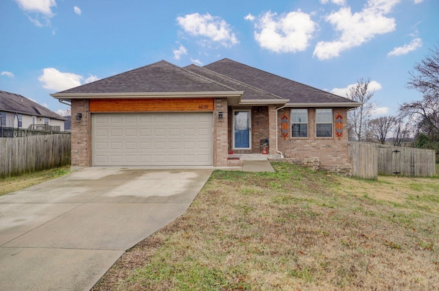 view of front of house featuring a garage and a front lawn