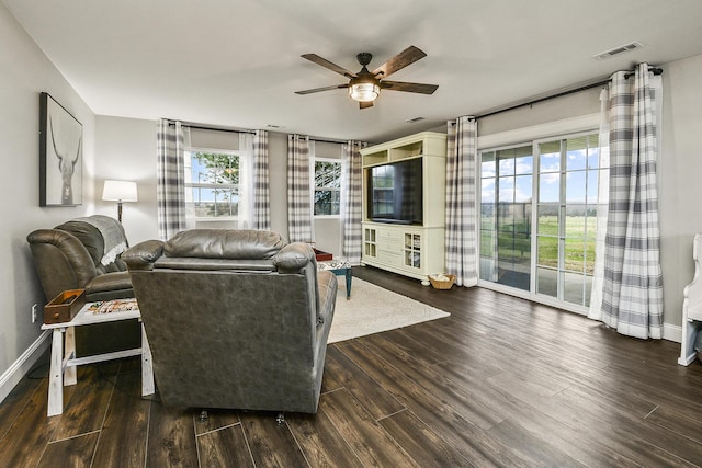 living room with dark hardwood / wood-style flooring and ceiling fan