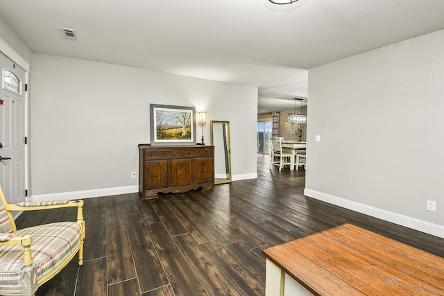 sitting room with dark wood-type flooring