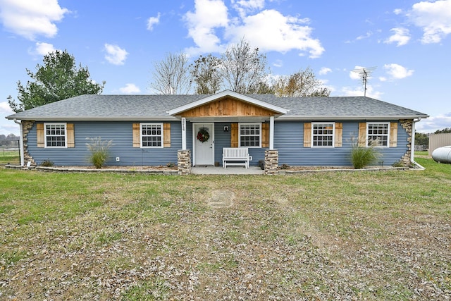 single story home with covered porch and a front yard