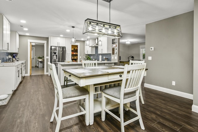 dining room with dark hardwood / wood-style flooring