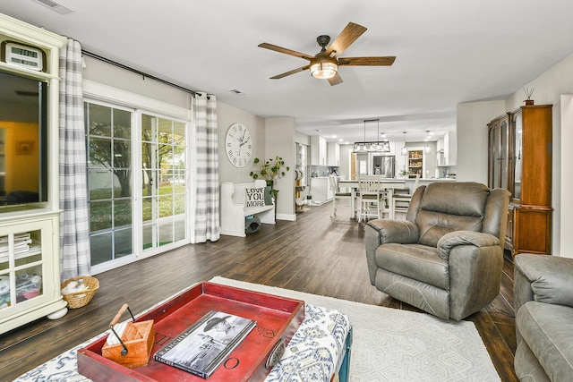 living room with dark hardwood / wood-style floors and ceiling fan