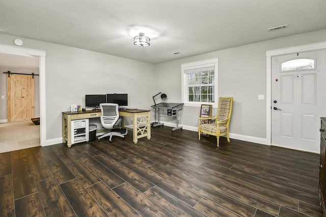 office area featuring a barn door and dark wood-type flooring