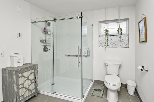 bathroom with tile patterned floors, an enclosed shower, and toilet