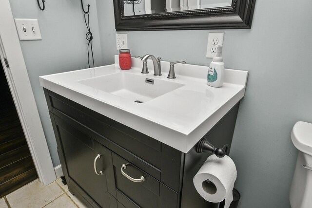 bathroom featuring tile patterned floors, vanity, and toilet