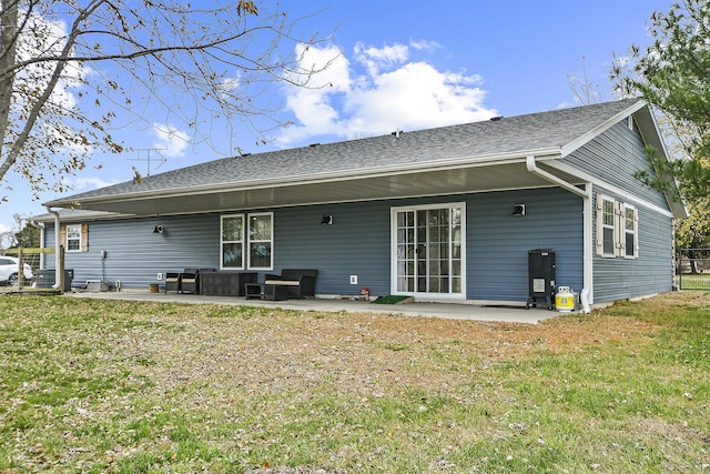 rear view of house featuring a lawn and a patio area