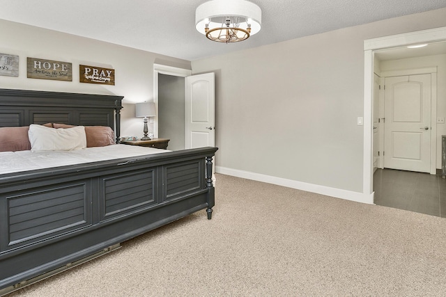 bedroom with carpet flooring, a textured ceiling, and an inviting chandelier