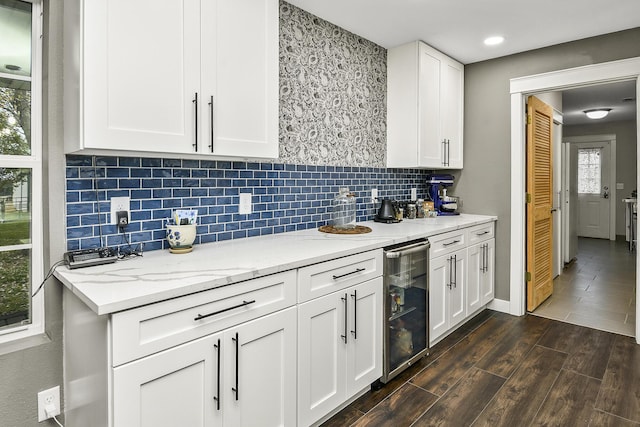 2314 State Highway 38, Elkland, MO 65644 - kitchen with beverage cooler, dark wood finished floors, white cabinetry, light stone countertops, and tasteful backsplash