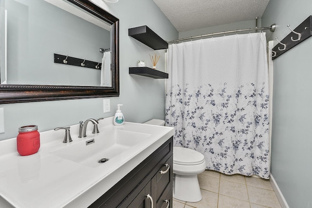 bathroom with toilet, vanity, a textured ceiling, and tile patterned floors