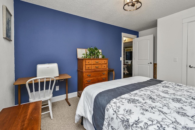 bedroom with carpet floors and a textured ceiling