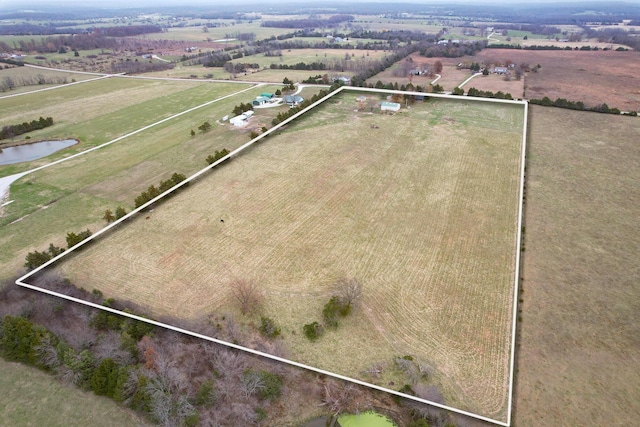 drone / aerial view featuring a rural view and a water view