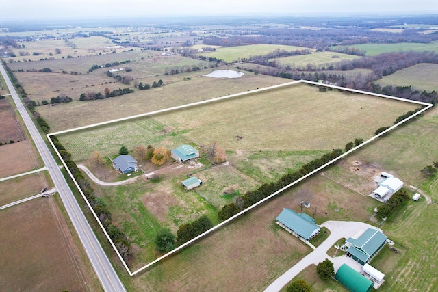 birds eye view of property with a rural view