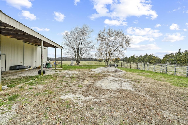 view of yard with an outbuilding and a rural view