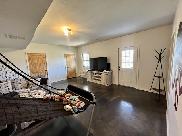 living room featuring a textured ceiling and a wealth of natural light