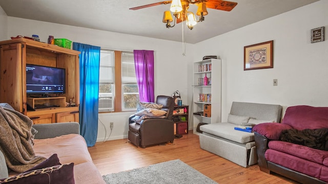 living room with ceiling fan and light hardwood / wood-style floors