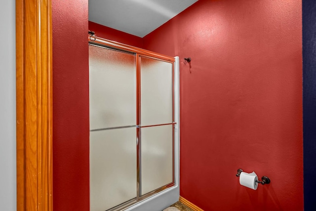 bathroom with a shower with shower door