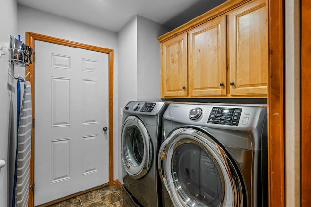 washroom featuring cabinets and washing machine and dryer