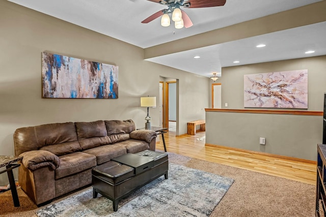 living room featuring hardwood / wood-style flooring and ceiling fan