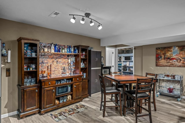 dining space with light wood-type flooring