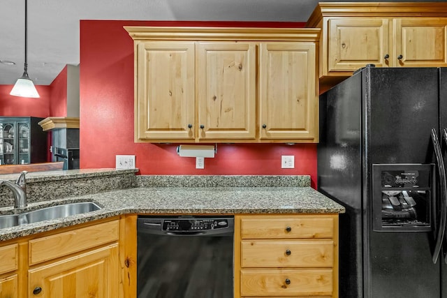 kitchen featuring black appliances, pendant lighting, and sink