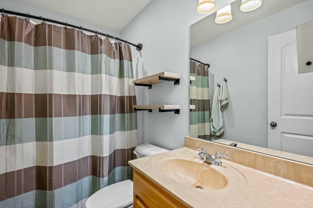 bathroom featuring walk in shower, vanity, and toilet