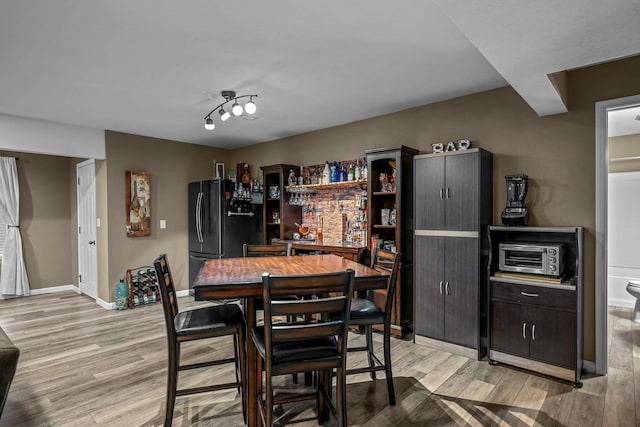 dining space with light hardwood / wood-style floors