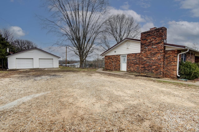 view of yard featuring an outbuilding and a garage