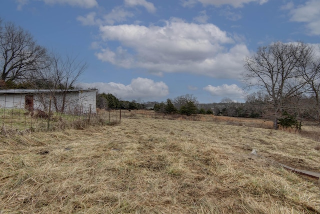 view of yard with a rural view