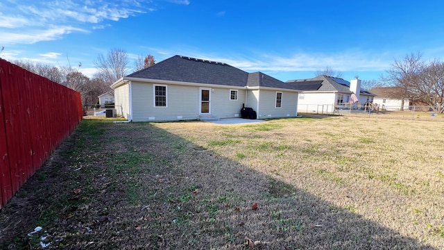 rear view of house featuring a lawn and a patio