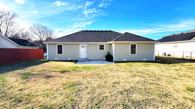 back of property featuring a lawn and a patio