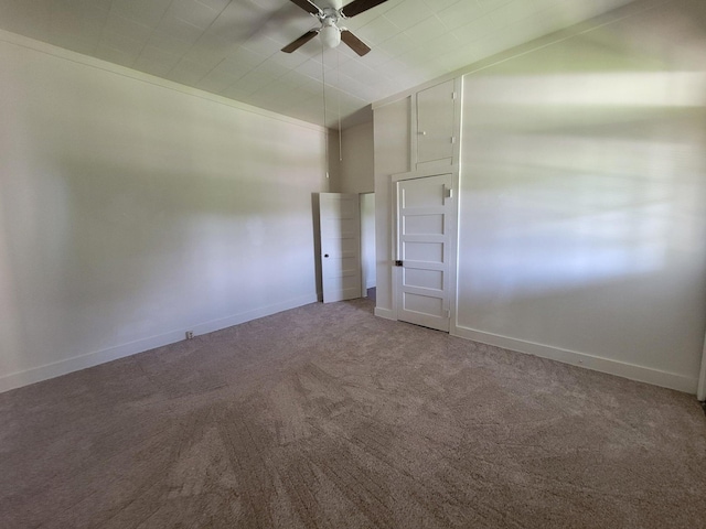 carpeted spare room with ceiling fan and ornamental molding