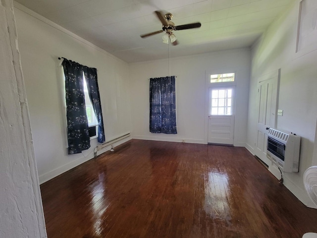 interior space featuring hardwood / wood-style floors, heating unit, baseboards, and a baseboard radiator