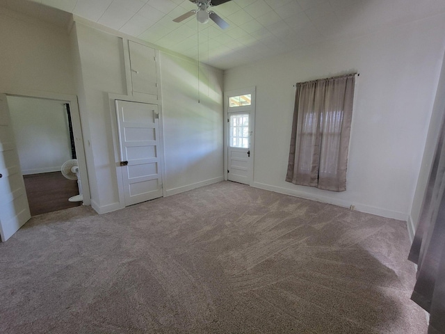 unfurnished bedroom with baseboards, carpet, and a ceiling fan