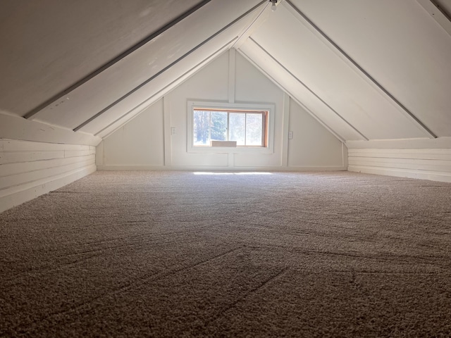 bonus room featuring lofted ceiling and carpet