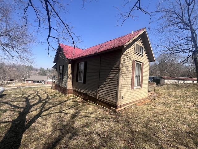 view of property exterior featuring metal roof