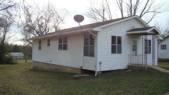 back of house with a yard