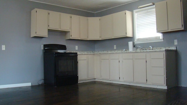 kitchen with light stone countertops, dark hardwood / wood-style flooring, white cabinetry, and black range with electric cooktop